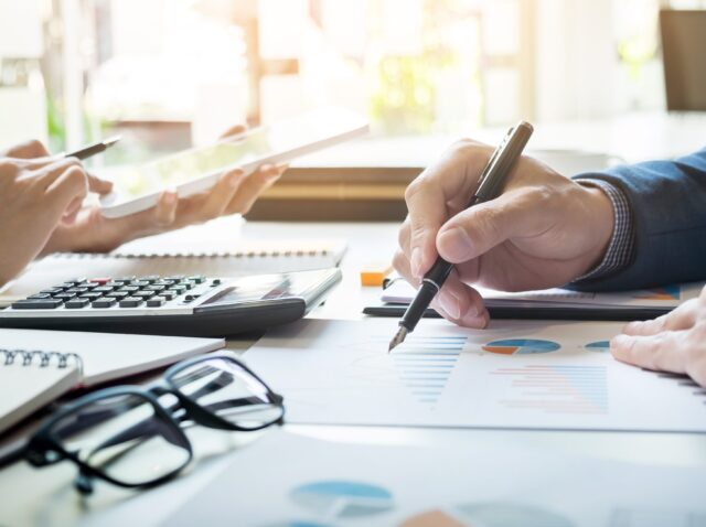 business-man-financial-inspector-and-secretary-making-report-calculating-or-checking-balance-internal-revenue-service-inspector-checking-document-audit-concept-e1635147822675