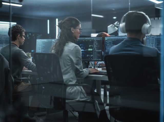 Group of Multicultural Men and Women Working in a Research Center, Collaborating and Discussing a Project, Using Computers to Write Advanced Software Code, Develop Artificial Intelligence Service